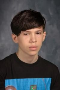 student with short hair and black top