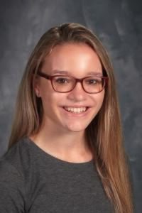 student with glasses and longer hair over shoulders