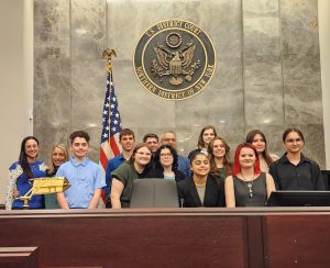 students and advisors of mock trial on dais at courthouse