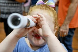 student looks through microscope