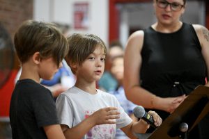 two kids on a microphone