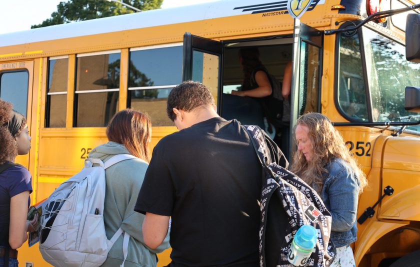 students getting on bus