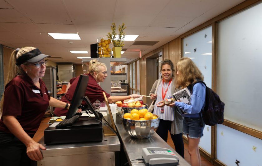 people ordering food in cafeteria