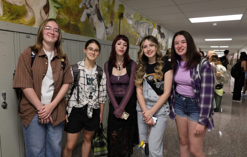 five students standing in the hall