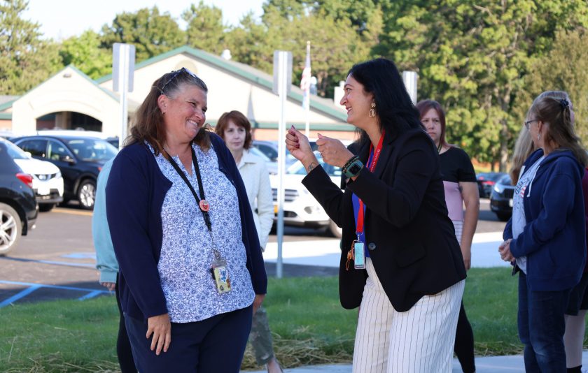 teachers laughing outside school