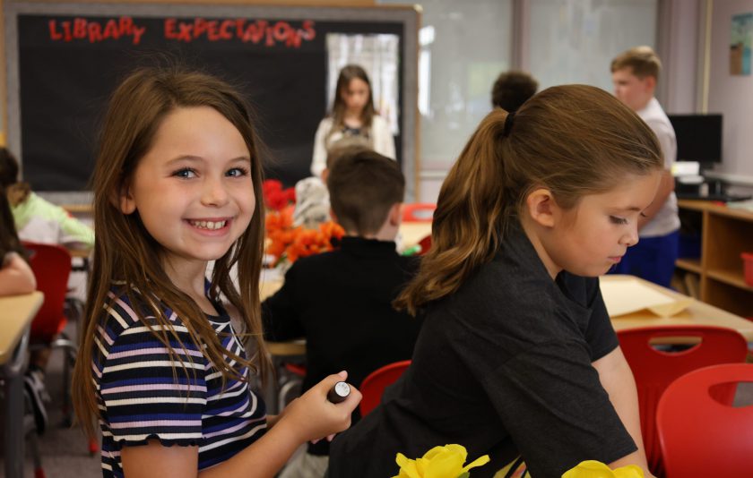 student looking over smiling