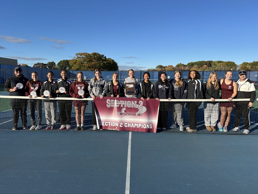 tennis players standing behind the net with a section 2 championship sign in front of them