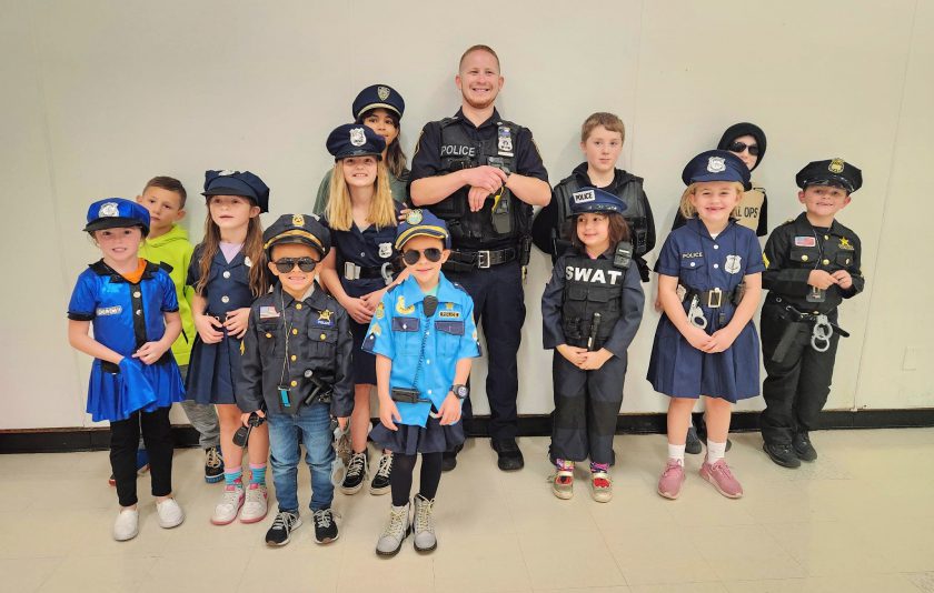 students dressed in halloween costumes with their School Resource Officer