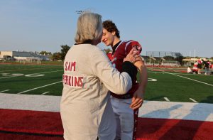 grandmother and grandson on football field