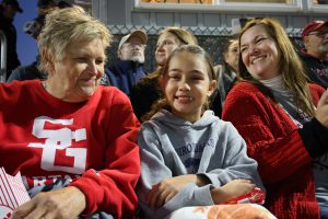 family and fans in the stands at a football game