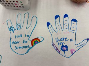 two hands traced with marker and decorated with kind sayings