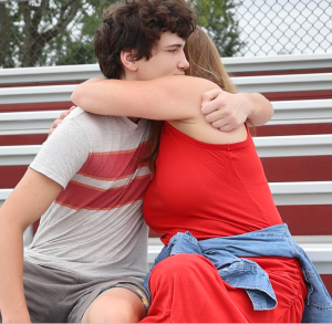 son hugs his mom on bleachers