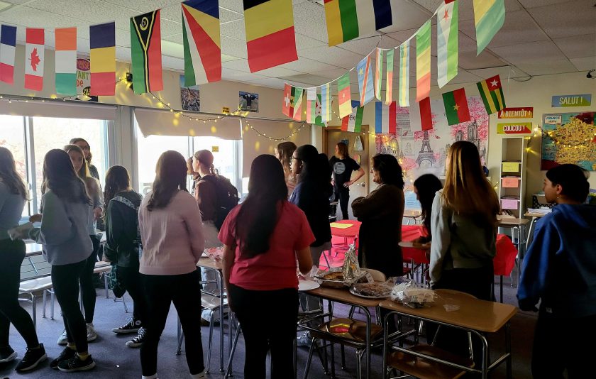 students standing under colorful flags