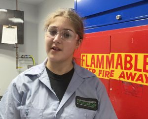 student wearing auto gear and googles in class