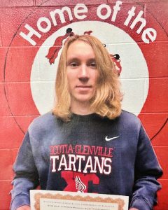 student with shoulder length blonde hair holds certificate