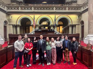 from the floor of the Assembly parlor students and teachers stand with their state assemblyman