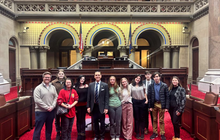 from the floor of the Assembly parlor students and teachers stand with their state assemblyman