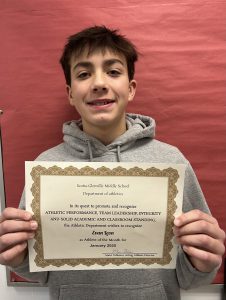 student smiling holding his certificate of achievement