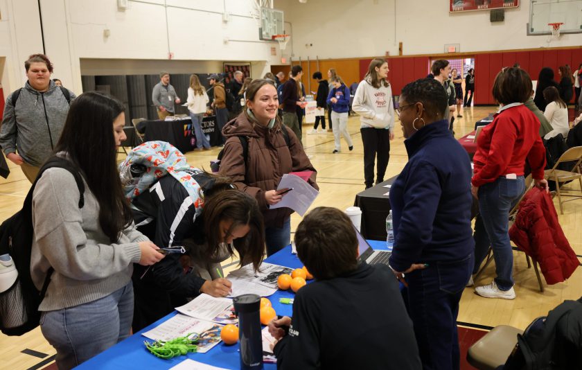 students seeking jobs at a job fair in their gym