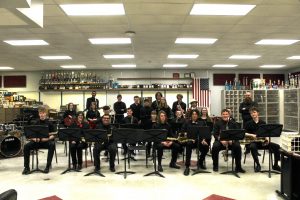 Jazz band sitting and standing with their instruments