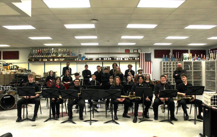 Jazz band sitting and standing with their instruments